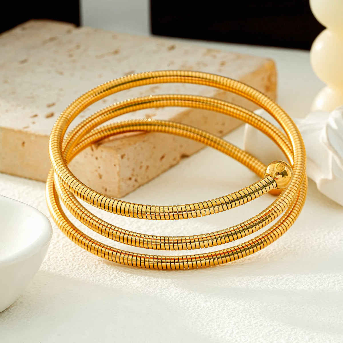 BASHEE : Bracelet triple en or avec lignes de surface et perles décoratives.