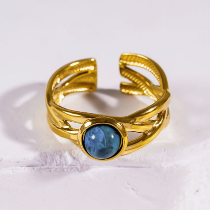CHESA : Bague empilable torsadée avec pierre naturelle centrale.
