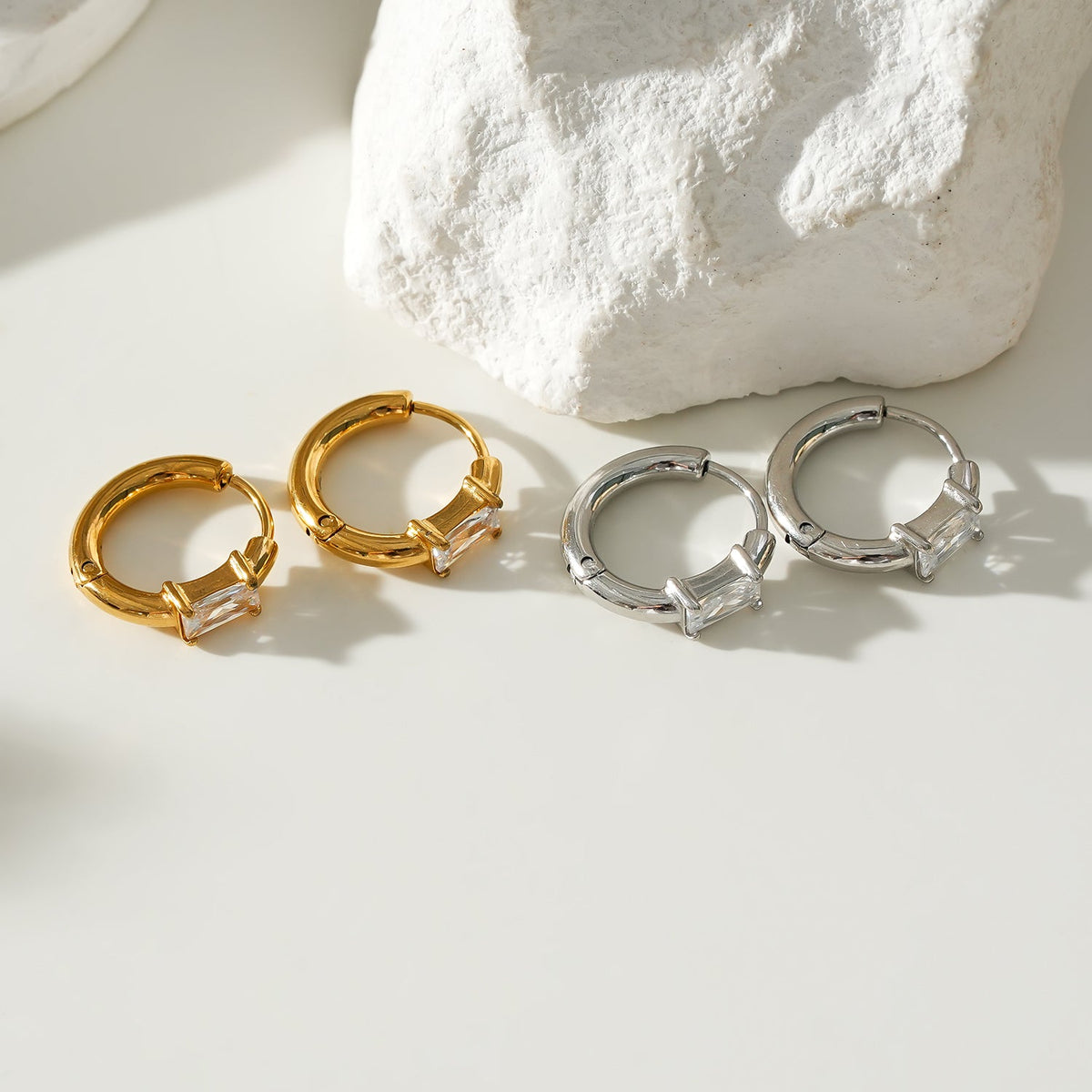 Style CONWYN: Retro Style Hoops with an Encased Clear Zirconia Charm in Silver.