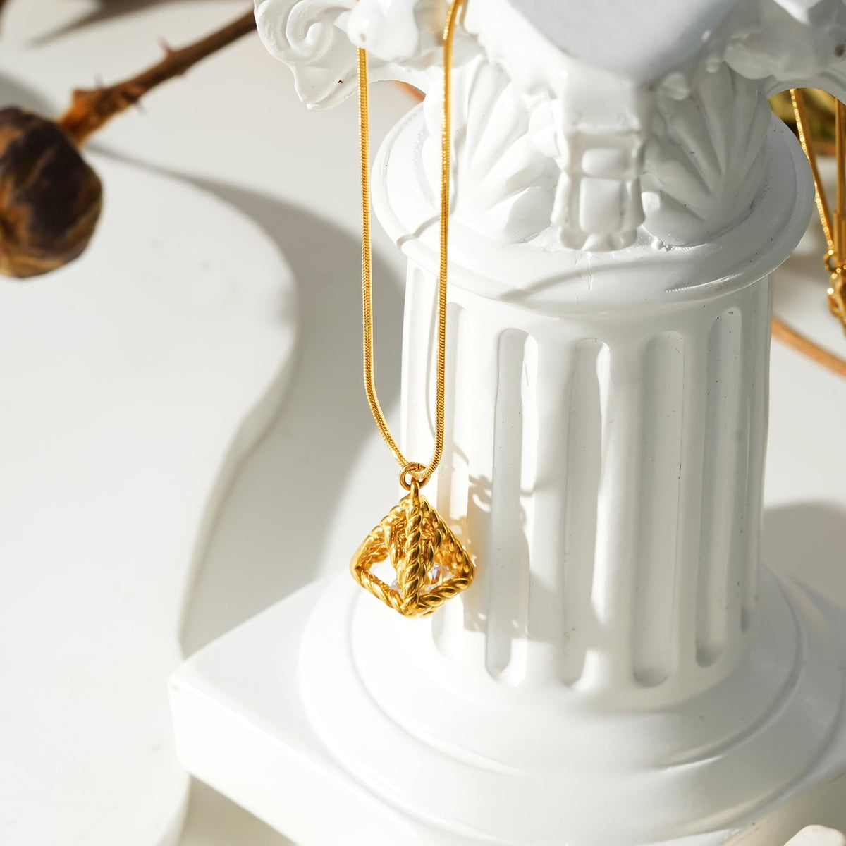 Style KARJAT: Gold Chain Necklace with Geometric Caged Zirconia Pendant