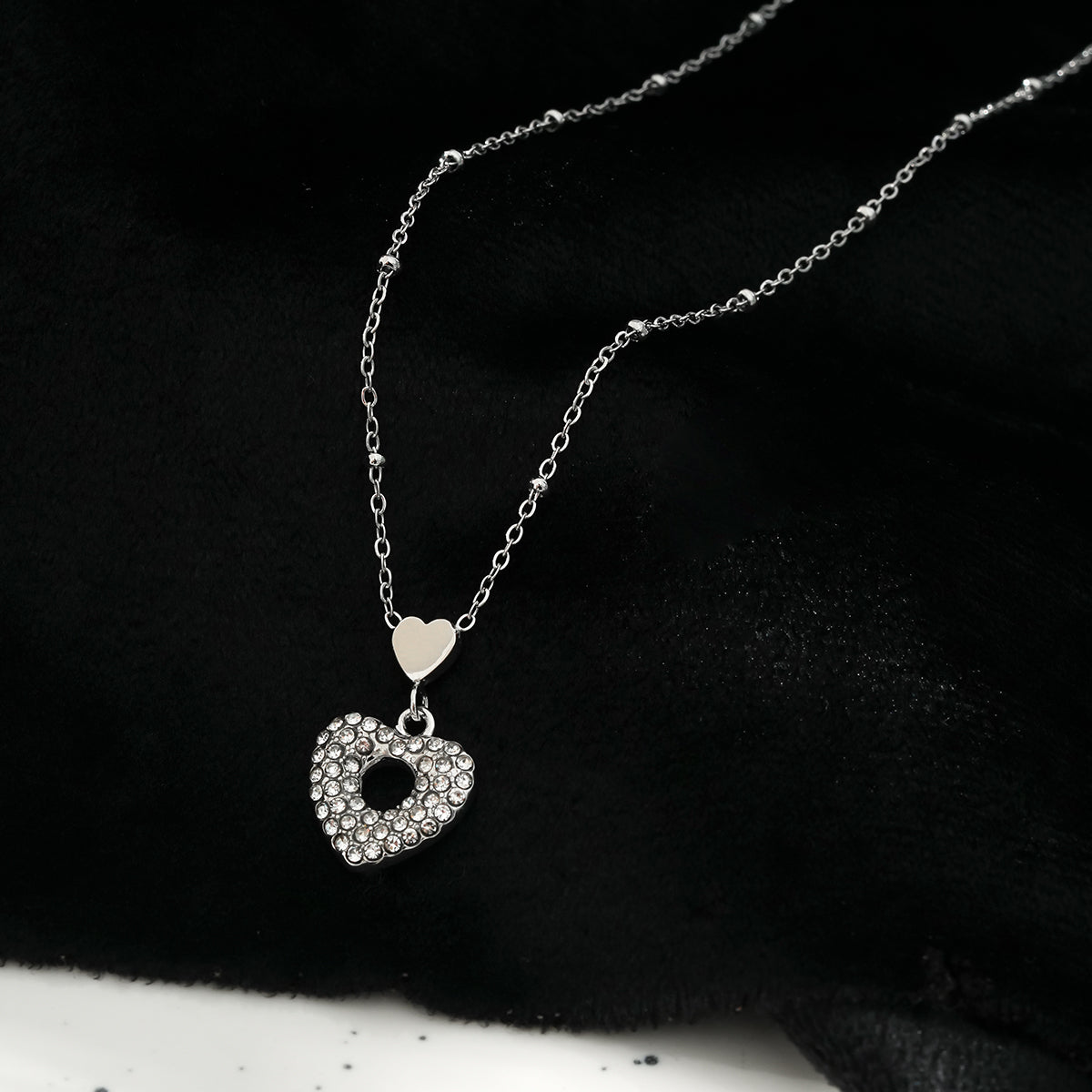 ETERNAL : Collier pendentif double cœur serti de zircones pavées