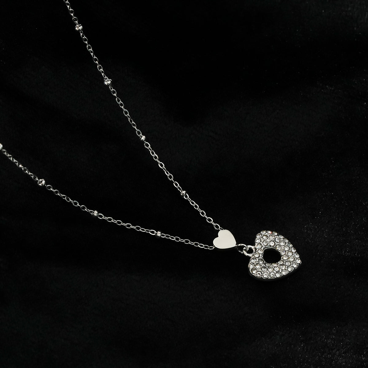 ETERNAL : Collier pendentif double cœur serti de zircones pavées