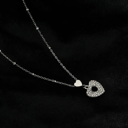 ETERNAL : Collier pendentif double cœur serti de zircones pavées