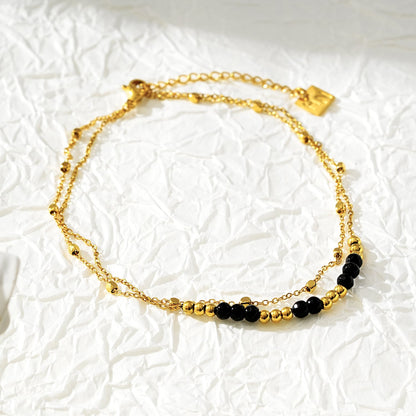 HILDA LG : Bracelet de cheville perles carrées et perles rondes deux-en-un noir et or.