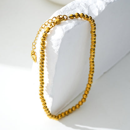 MANAMI LG : Chaîne de cheville contemporaine en or avec perles-boules