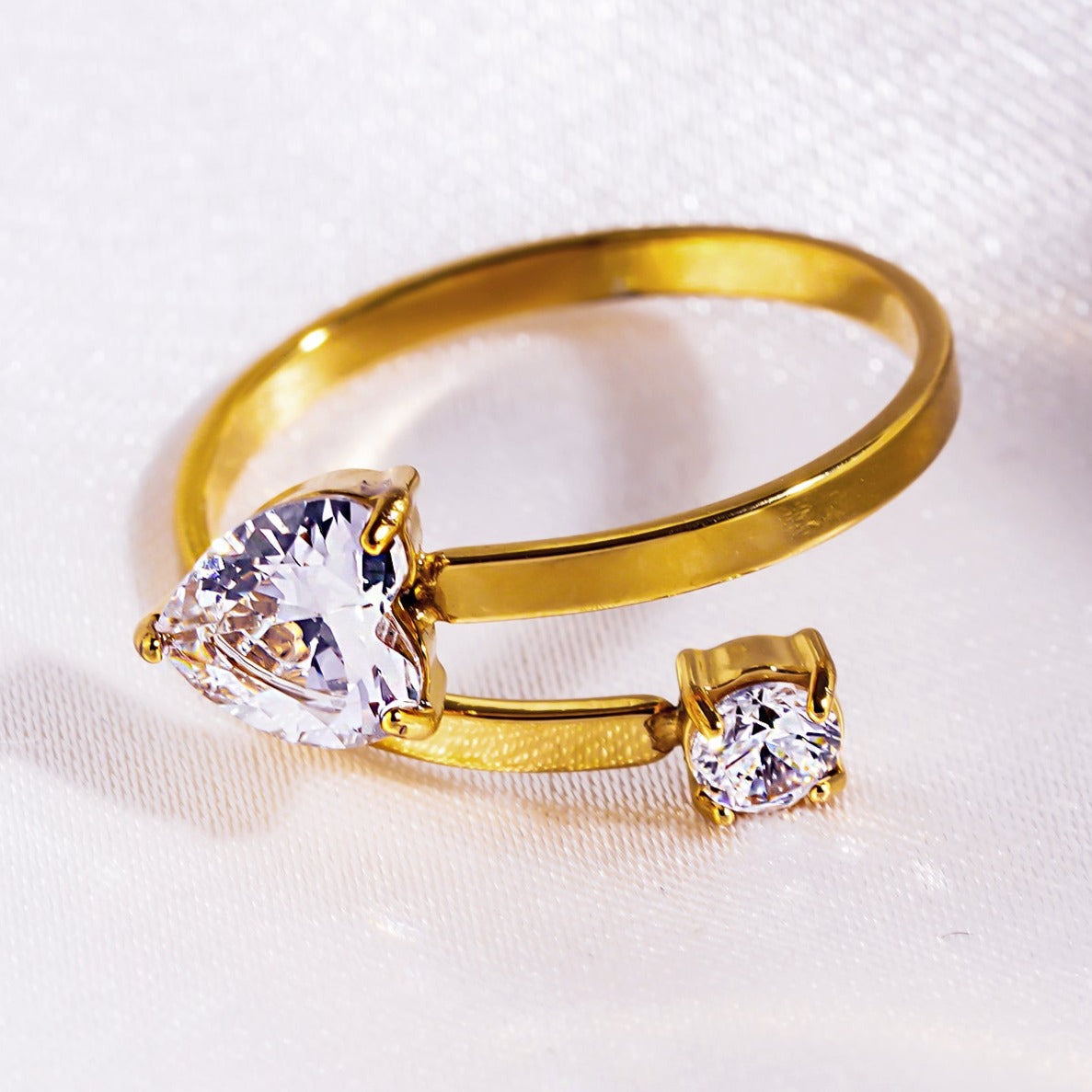 RIZALINA: Classic Band Ring Anchoring Heart Shaped & Rounded Zirconia Gemstones